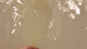 Uncut white dick pissing, masturbating, and cumming underwater in the bathtub, then plays with it